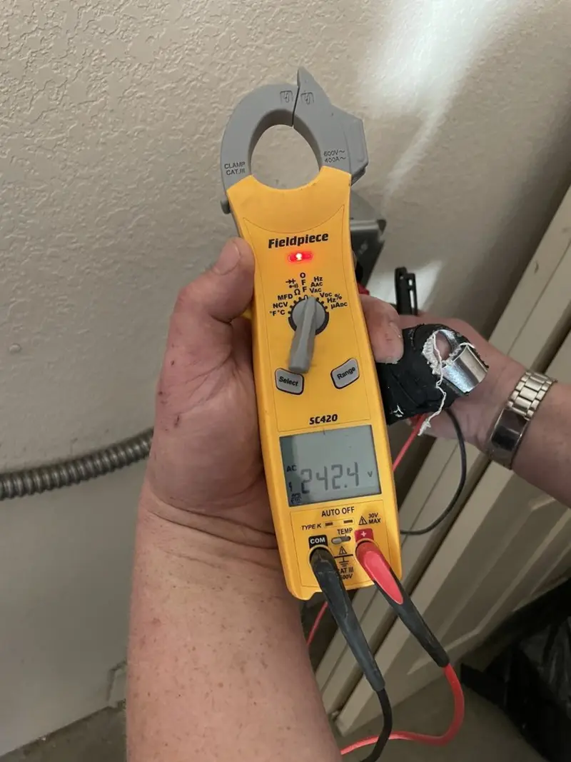 Voltage testing with clamp meter during Recessed Lighting Installation in Dana